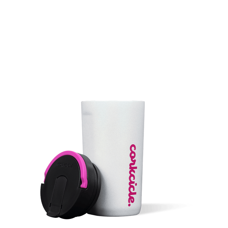 Sparkle Unicorn Magic Cup is a white silicone cup with "Corkcicle" written vertically in pink. The cap part is black and placed next to the cup and the handle is pink. 